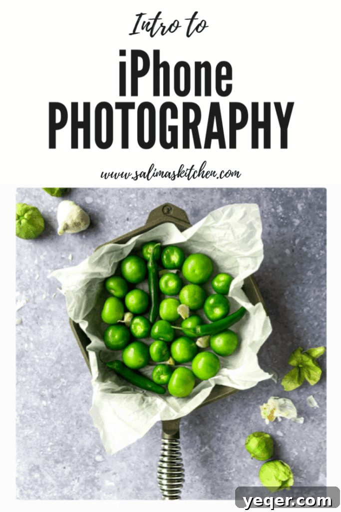 Shoot Like a Pro with Your iPhone 4 A close-up shot of a smartphone camera taking a picture of a delicious, colorful meal on a wooden table, emphasizing mobile food photography techniques.