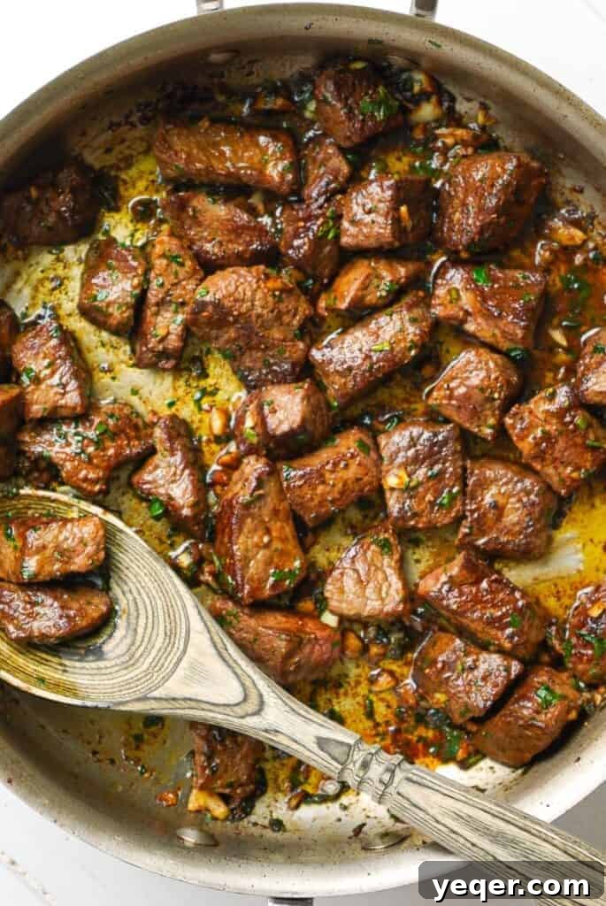 Sizzling Garlic Herb Steak Bites 6 Garlic Herb Steak Bites perfectly coated with butter, garlic, and herbs, sizzling in the pan.