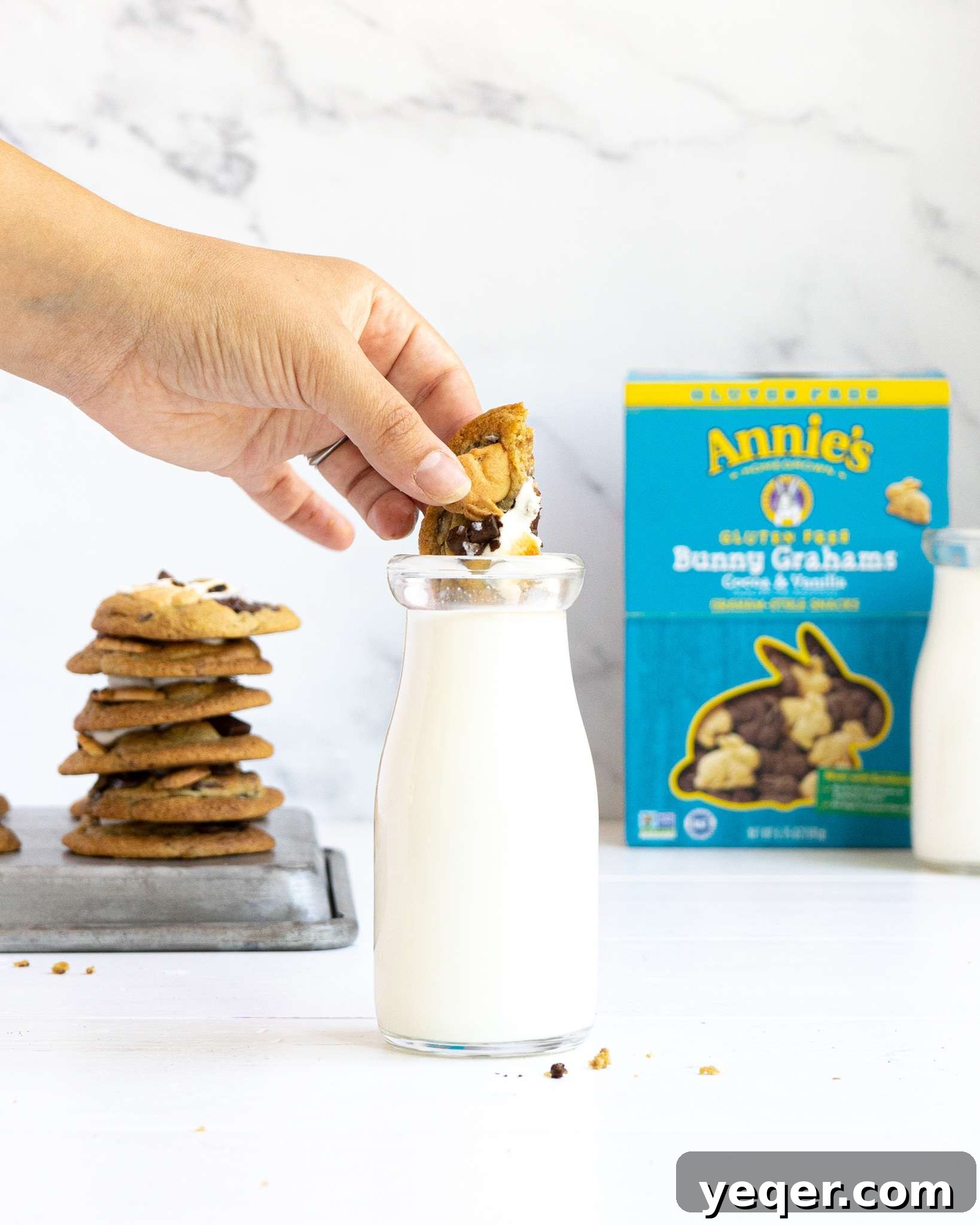 Gluten Free Smores Cookies with Annies and The Feed Feed 12 A s'mores cookie dipping into a jar of milk with an Annie's box in the background.