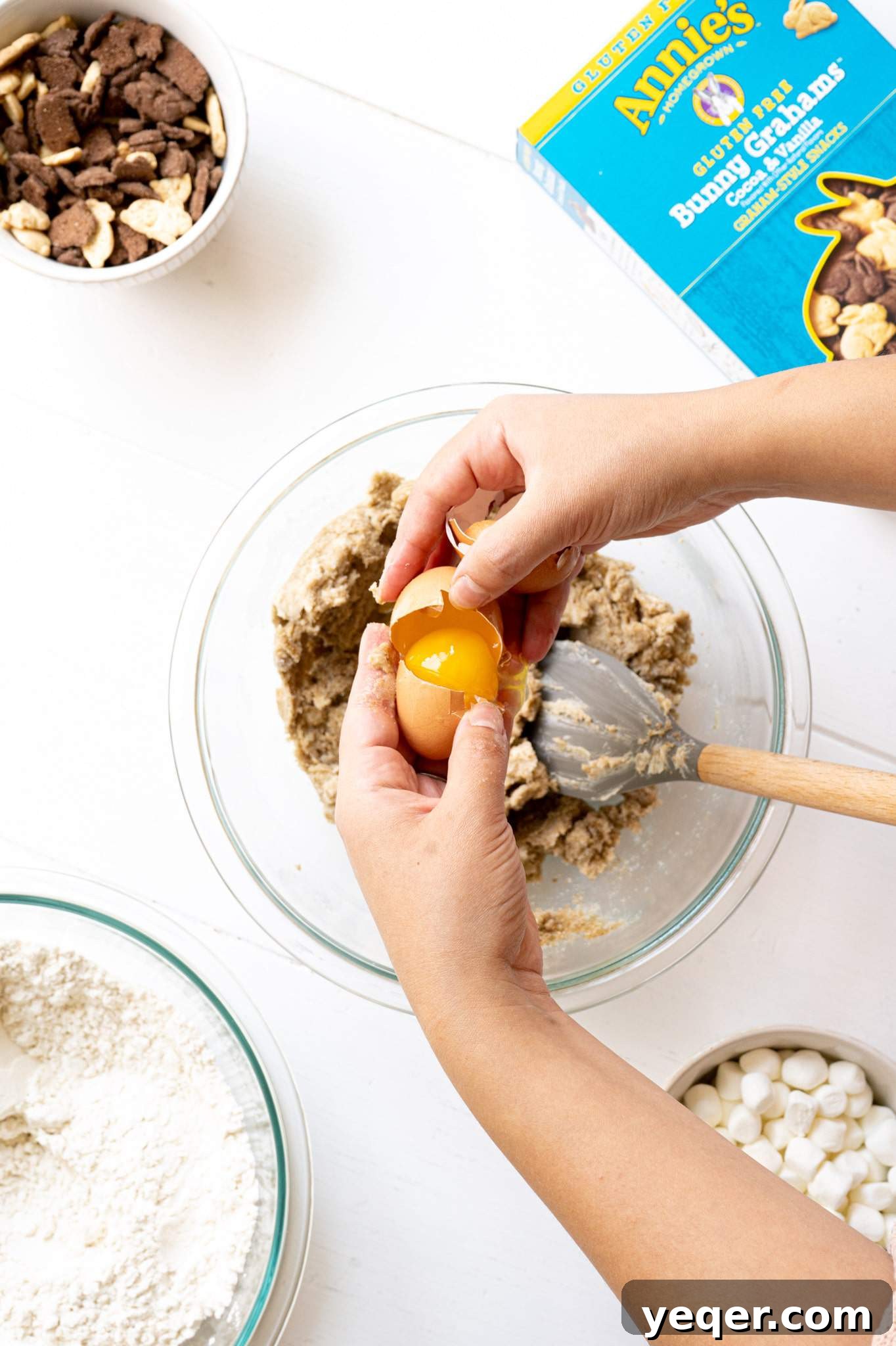 Gluten Free Smores Cookies with Annies and The Feed Feed 4 Two hands cracking an egg into s'mores cookie dough.