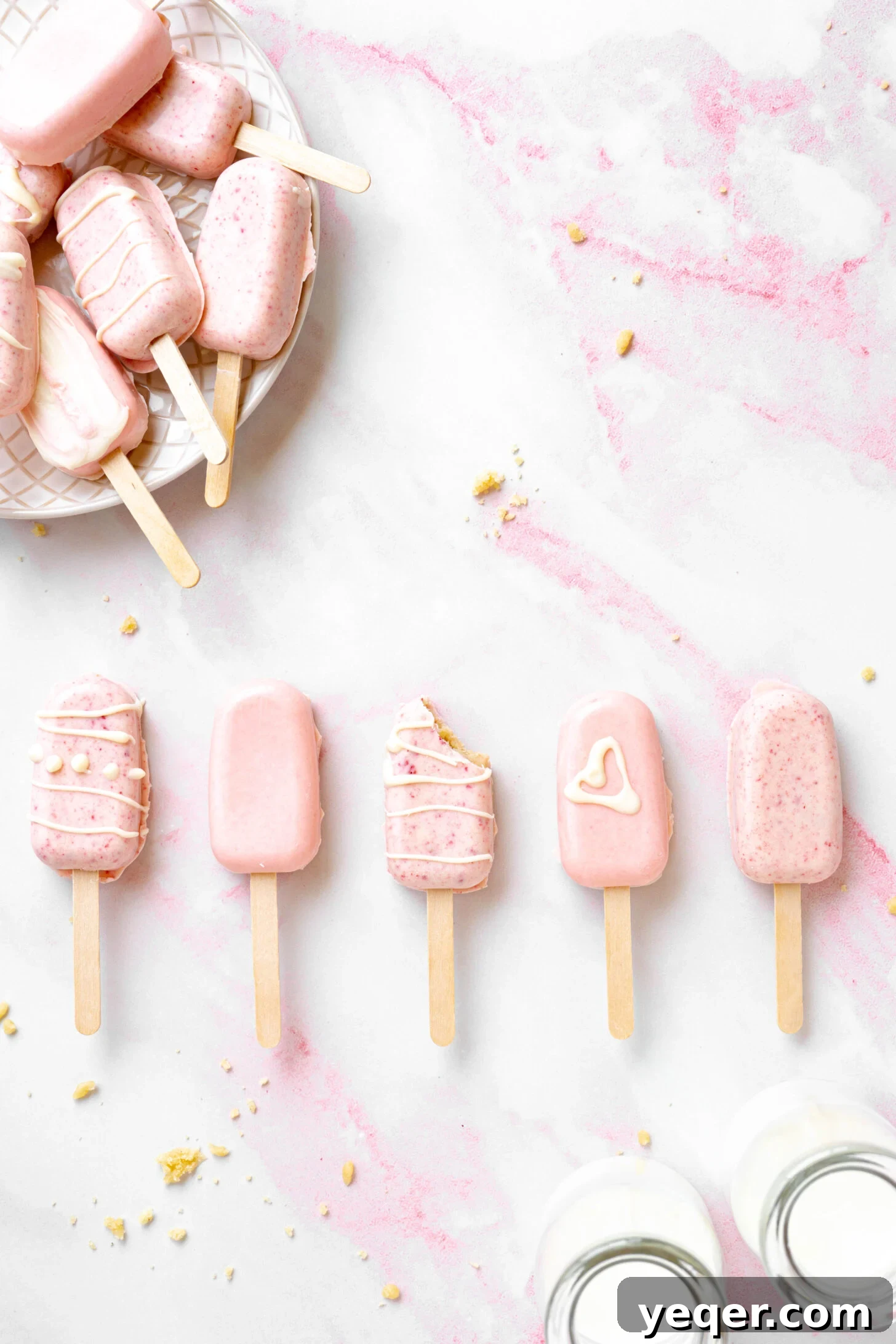 Whimsical Pink Pops 5 A row of pink cake pops with a bite taken out of one.