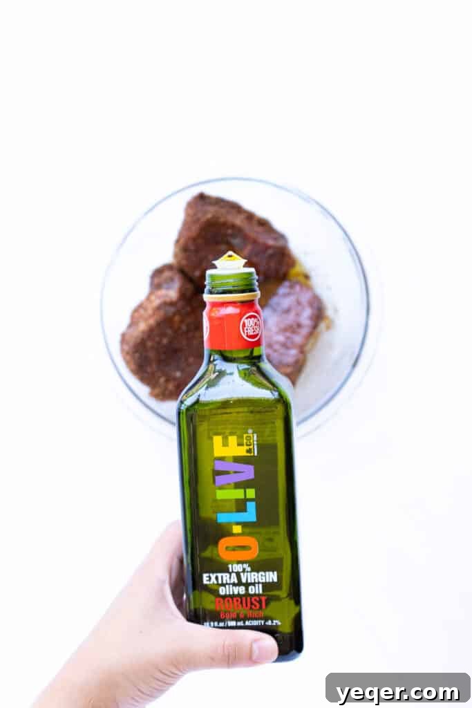 Effortless Sheet Pan Steak Fajitas 6 A generous drizzle of O-Live & Co. Robust olive oil coating steak strips seasoned with fajita spices.