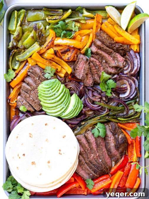 A sheet pan full of steak fajita fixings.