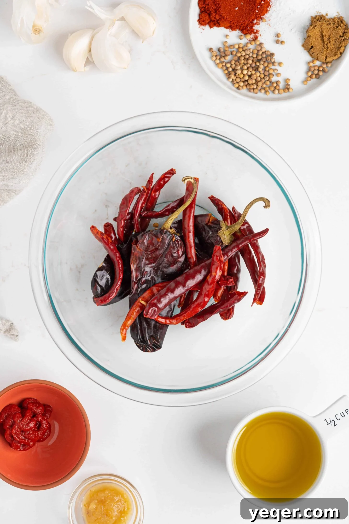 Unlocking Moroccan Flavor with Homemade Harissa 3 A vibrant display of fresh ingredients for making homemade harissa, including various dried red chiles, preserved lemons, and aromatic spices.