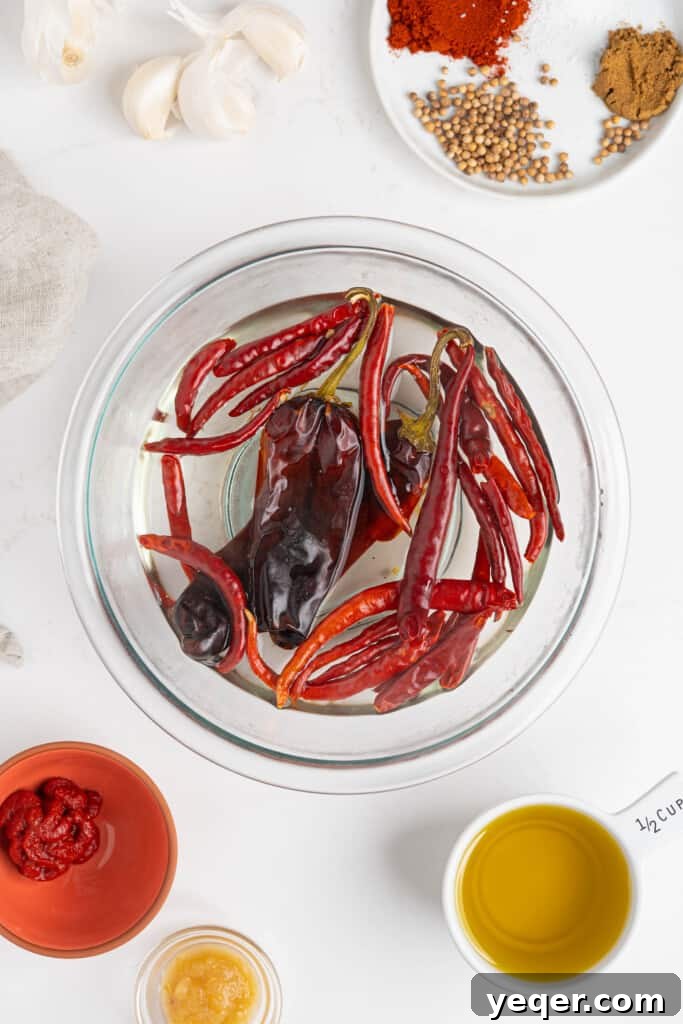 Unlocking Moroccan Flavor with Homemade Harissa 4 Dried red chiles soaking in a bowl of hot water, softening for the harissa paste.