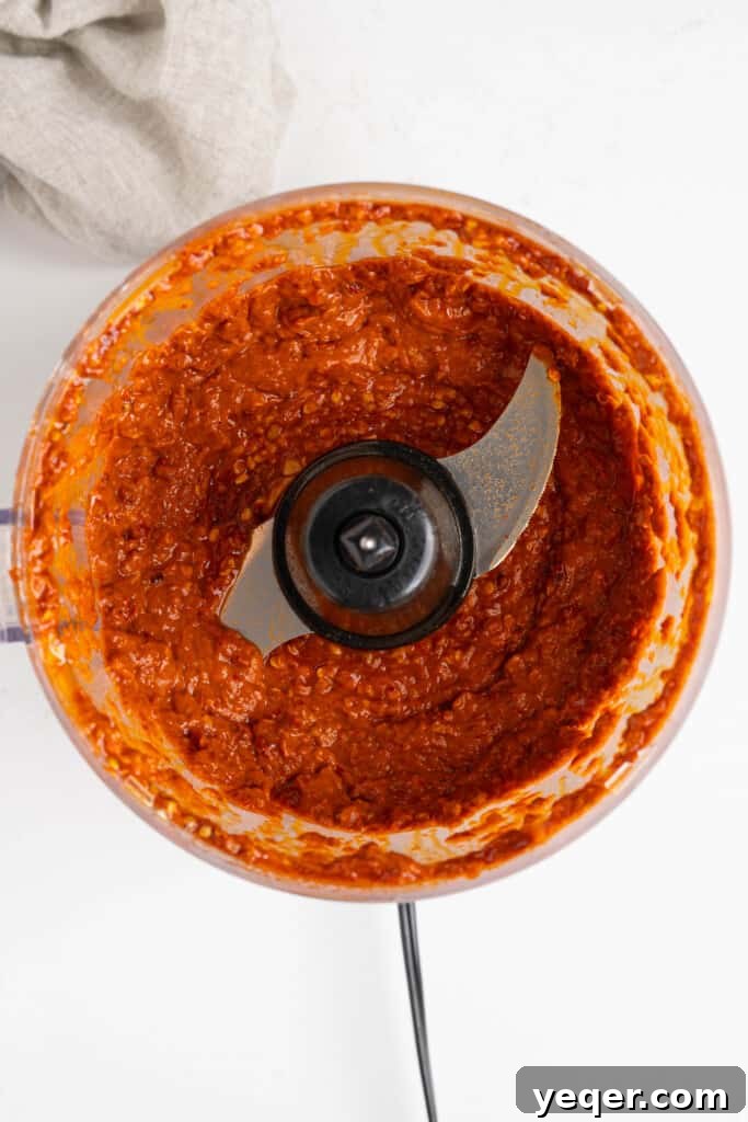 Unlocking Moroccan Flavor with Homemade Harissa 6 Harissa paste being processed in a food processor, blending into a smooth consistency.