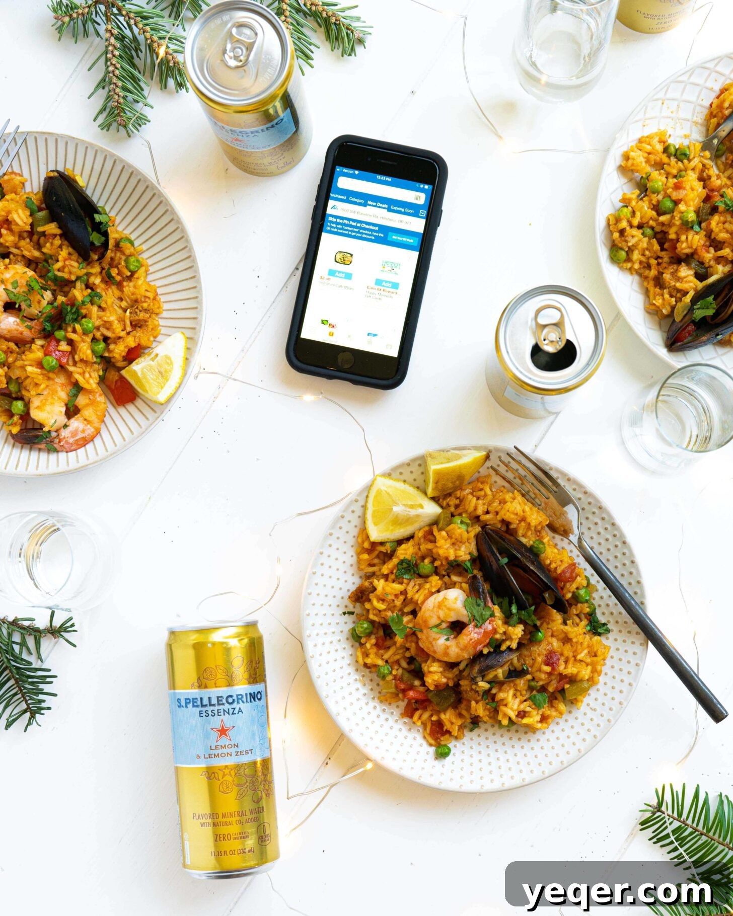 Golden Saffron Shrimp Paella 4 Plates of seafood paella next to cans, glasses and a phone
