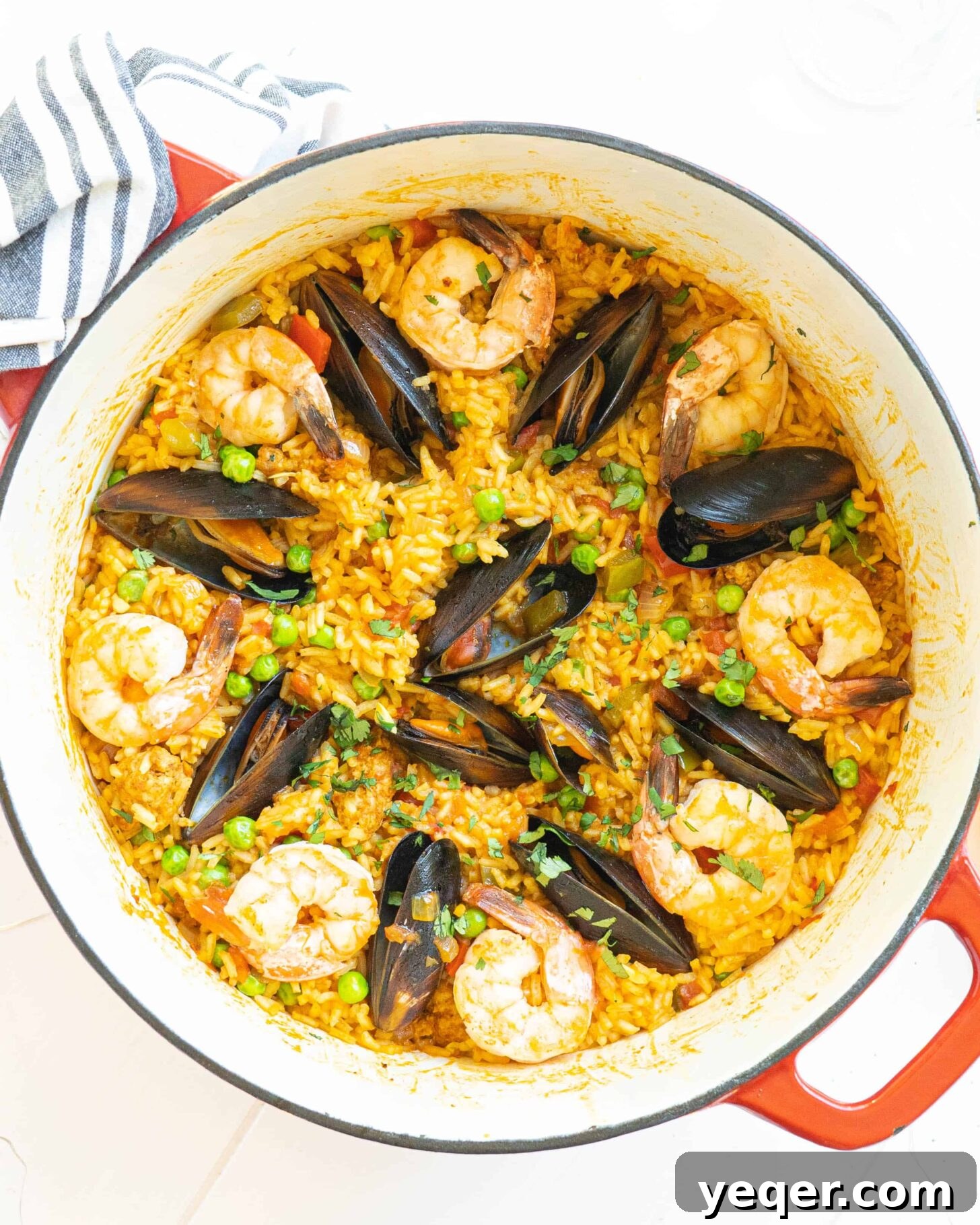 Golden Saffron Shrimp Paella 6 A pot full of seafood paella topped with mussels and shrimp