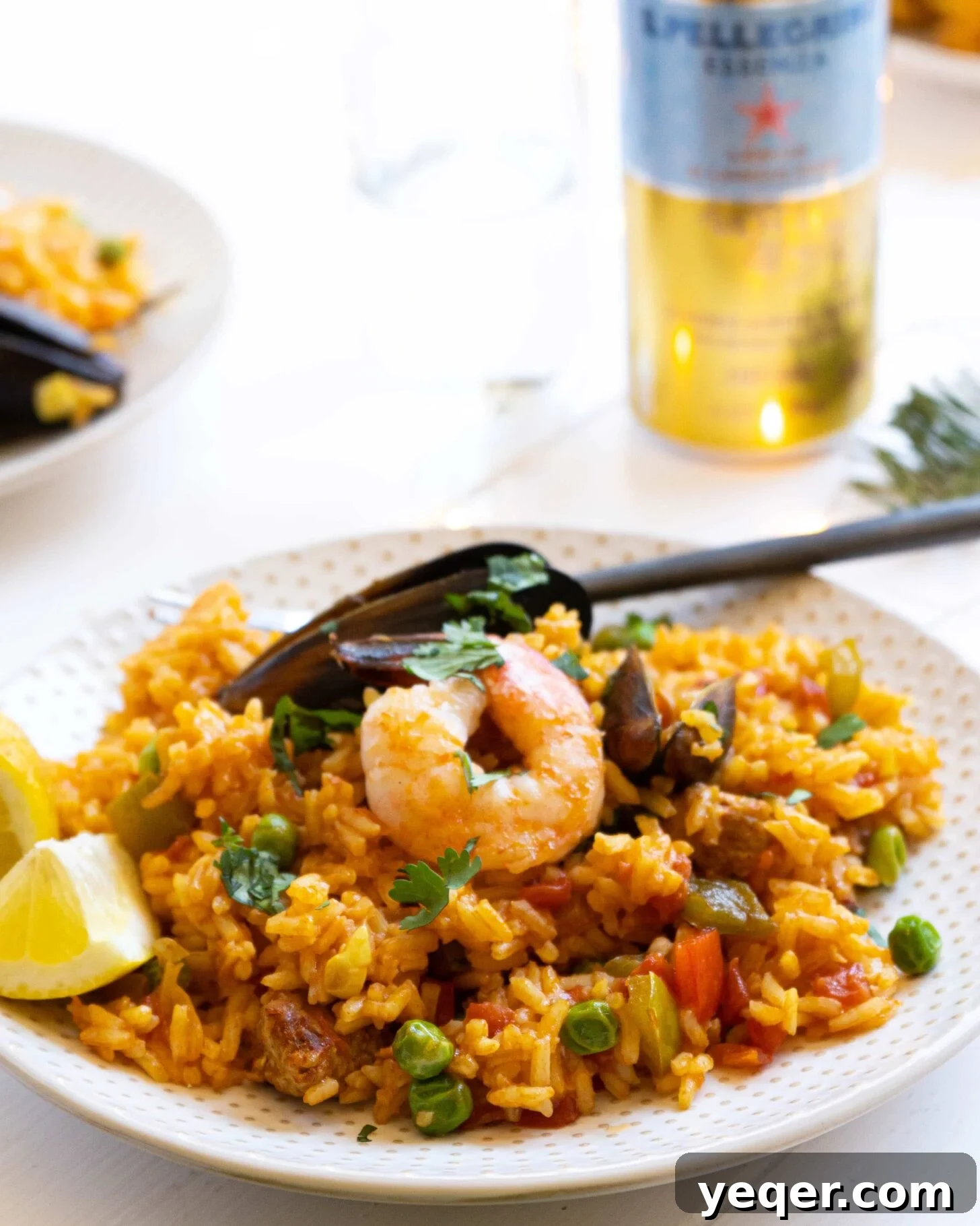 Golden Saffron Shrimp Paella 7 A plate full of seafood paella with shrimp and mussels.