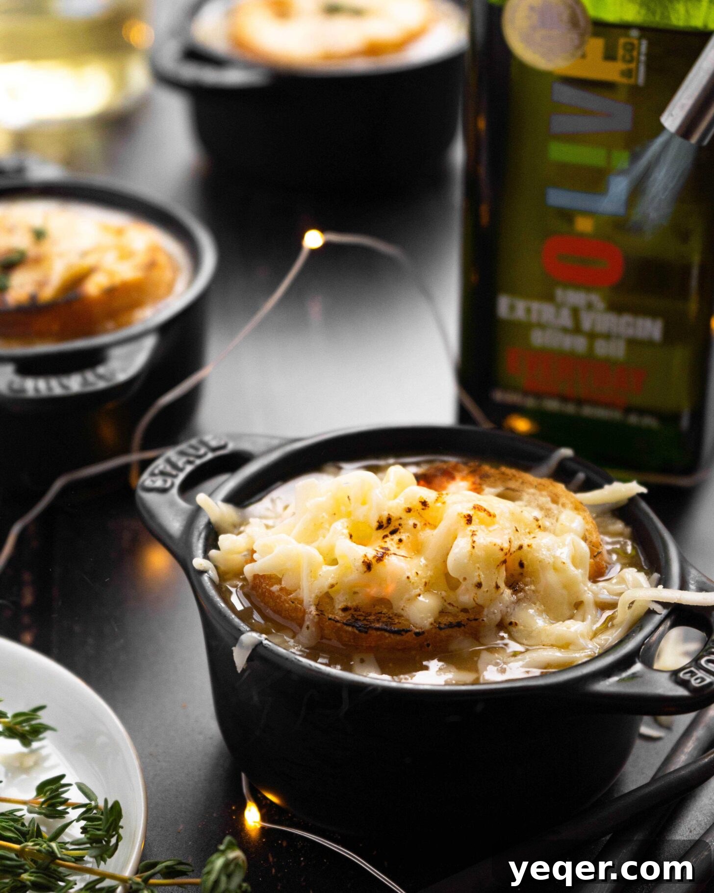 Homemade French Onion Soup Elevated with O-Live and Co 4 A torch melting cheese over a bowl of French Onion Soup