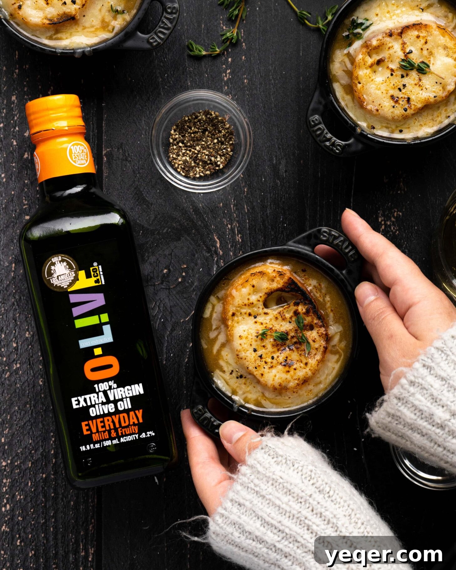 Homemade French Onion Soup Elevated with O-Live and Co 6 Two hands holding a bowl of French Onion Soup