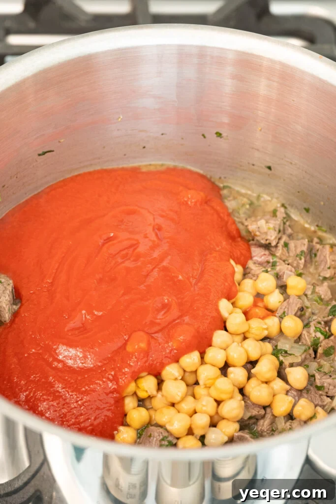 Moroccan Harira: A Spiced Lentil and Chickpea Comfort Soup 7 a pot with stew meat, chickpeas, and tomato puree