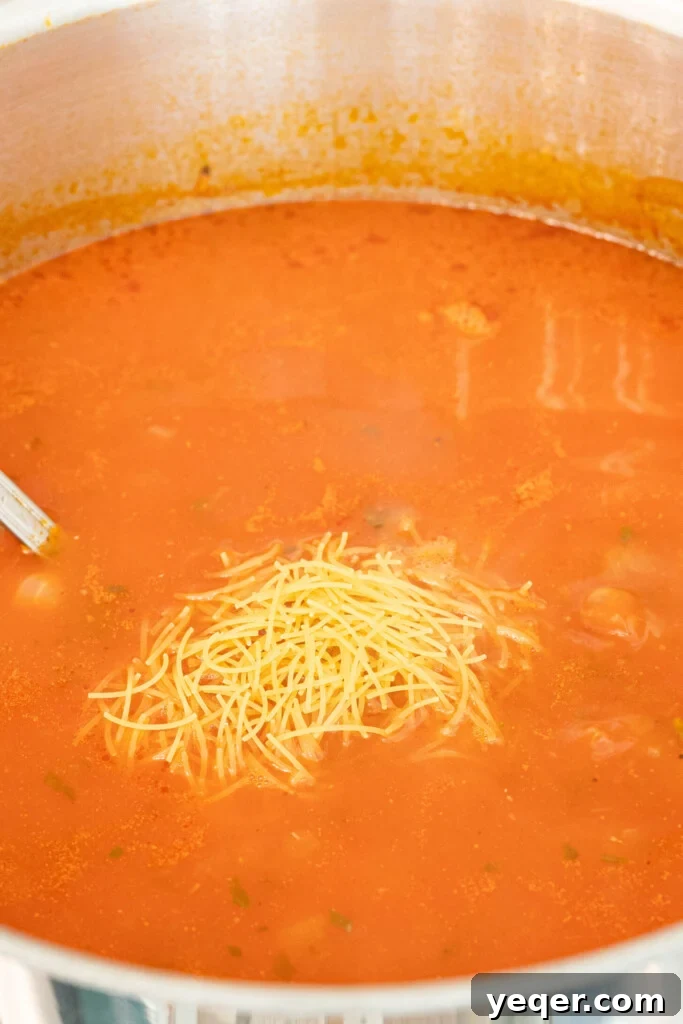 Moroccan Harira: A Spiced Lentil and Chickpea Comfort Soup 10 a pot of soup with vermicelli noodles