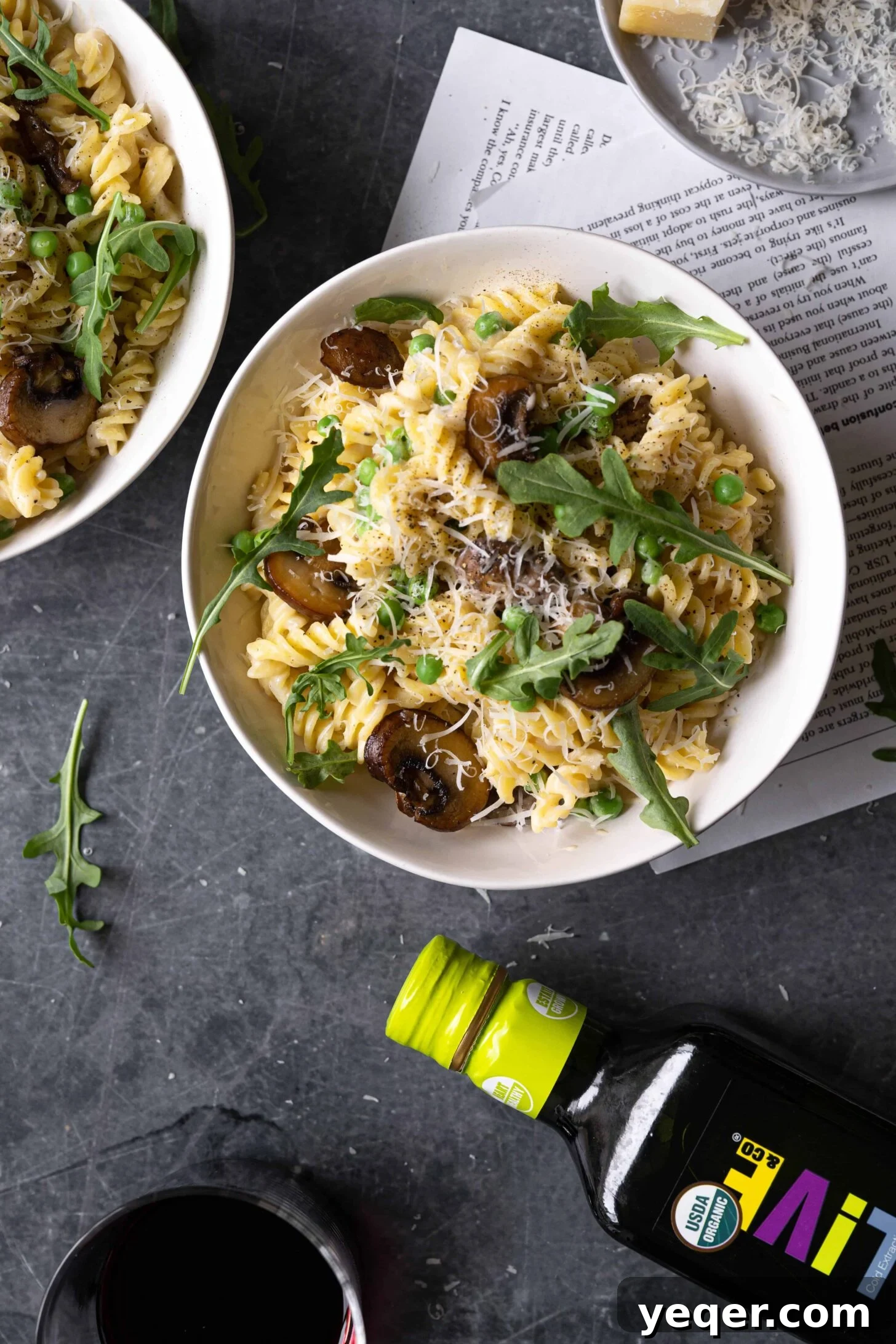 Savory Mushroom Medley Pasta 11 A close-up of the delicious vegetarian mushroom pasta with a bottle of O-Live Organic Olive Oil in the background.
