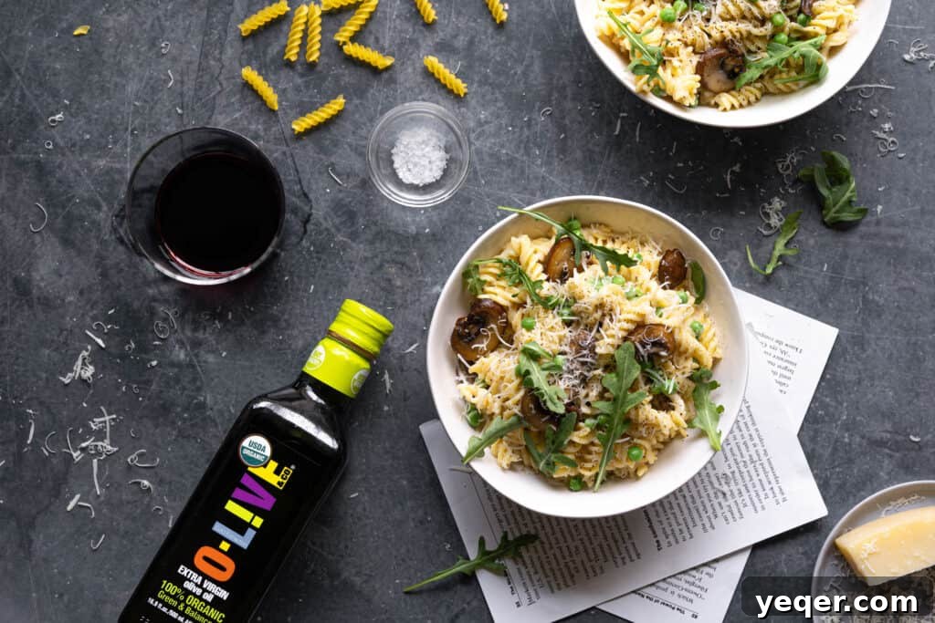 Savory Mushroom Medley Pasta 10 Two bowls of creamy mushroom pasta, garnished with fresh herbs, lemon, and parmesan.