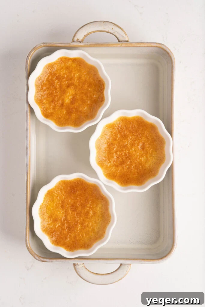 Silky Puerto Rican Caramel Flan 10 Freshly baked flan in ramekins, still in the water bath, cooling down.