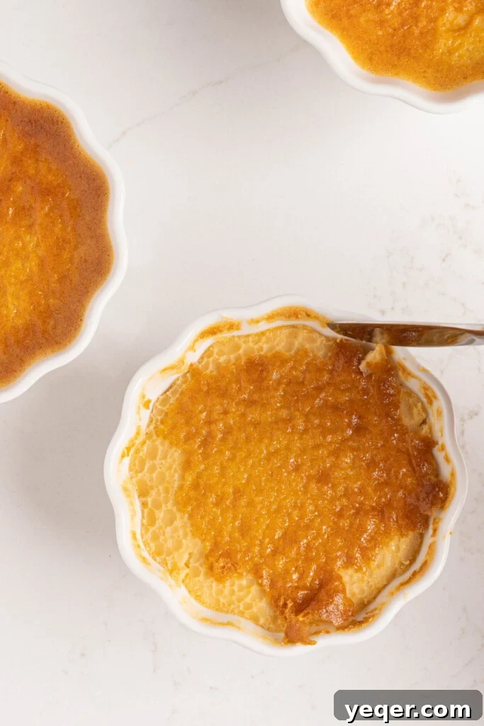 Silky Puerto Rican Caramel Flan 11 A knife gently loosening the edges of a cooked flan in a ramekin.