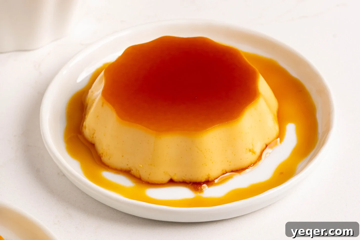 Silky Puerto Rican Caramel Flan 15 A pristine, creamy slice of flan on a plate, garnished simply, highlighting its smooth texture and rich caramel.