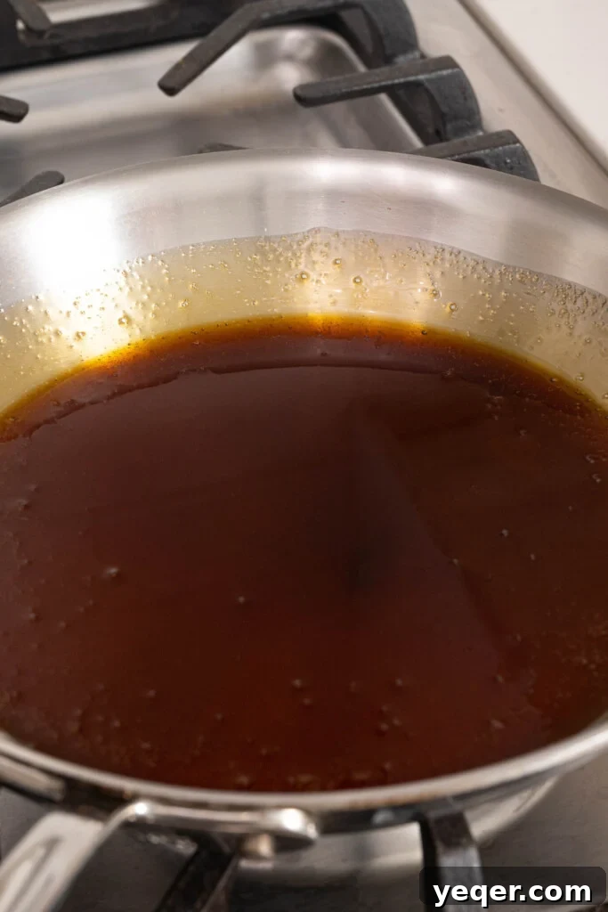 Silky Puerto Rican Caramel Flan 5 Smooth, light golden-brown caramel coating the bottom of a pan, ready to be poured.