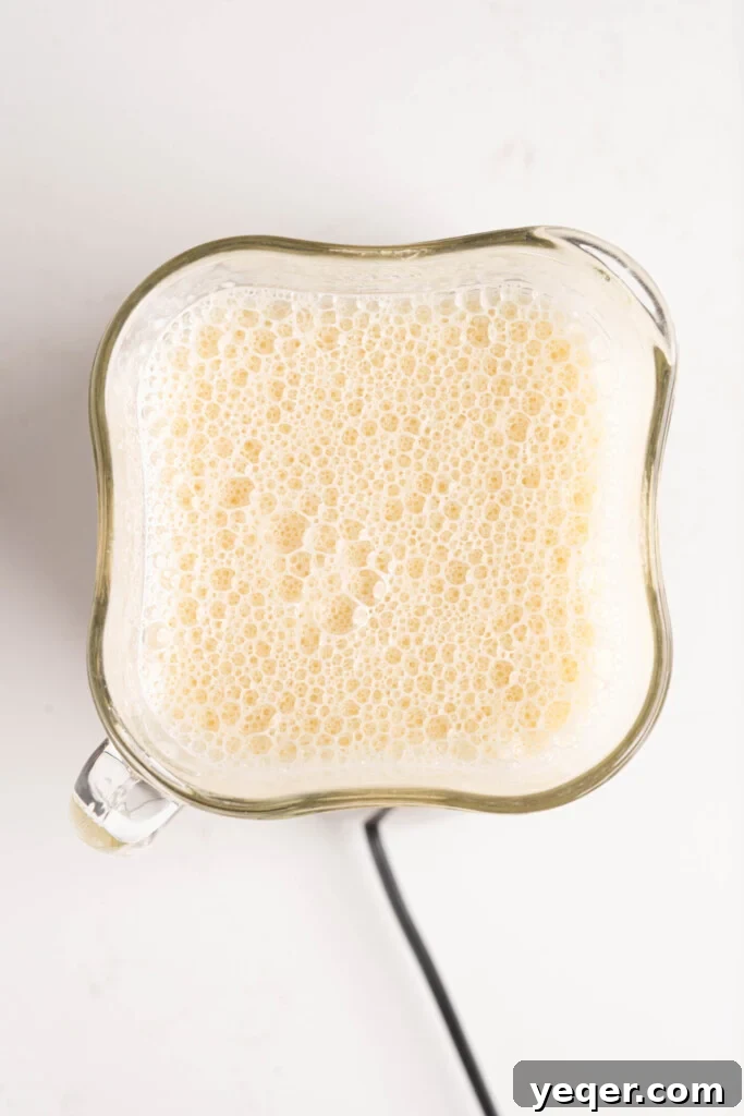 Silky Puerto Rican Caramel Flan 8 Smooth, pale yellow flan mixture in a blender, ready to be poured.