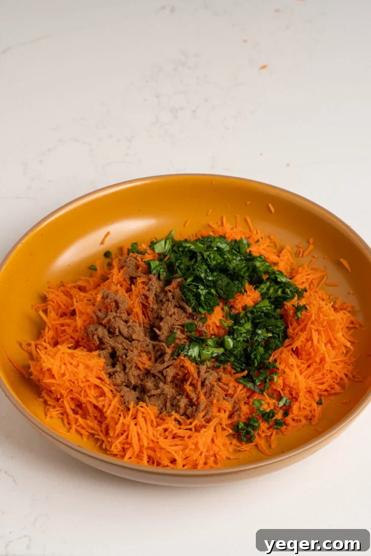 Zesty 10-Minute Moroccan Grated Carrot Salad 5 A bowl of grated carrot with cinnamon and parsley ready for mixing.