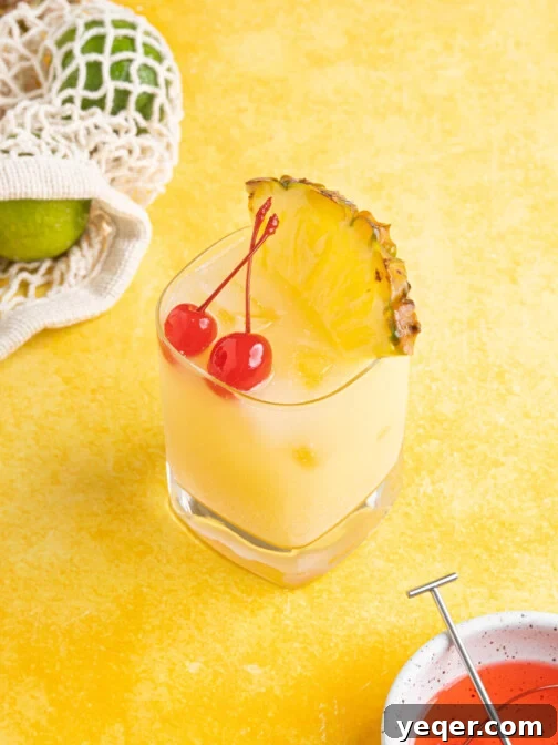 A vibrant Pina Colada on the rocks, garnished beautifully on a yellow background, capturing the essence of a refreshing tropical cocktail.