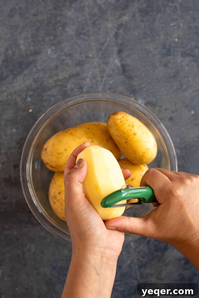 Moroccan Grandma's Fiery Potato Salad 3 two hands peeling a potato