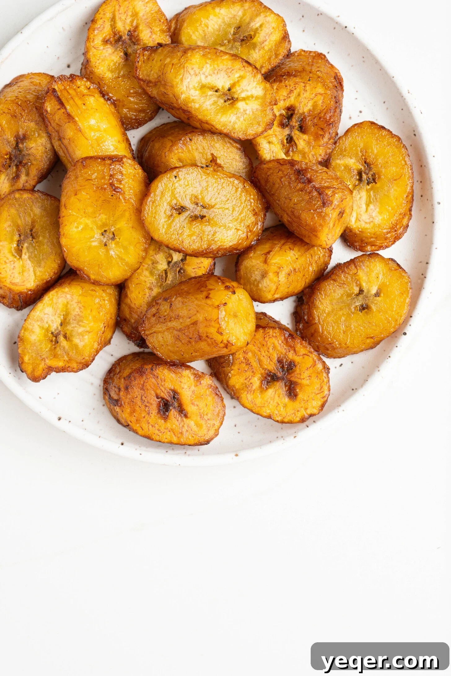 Caramelized Golden Plantains 11 A styled bowl of sweet fried plantains, garnished and ready for serving.