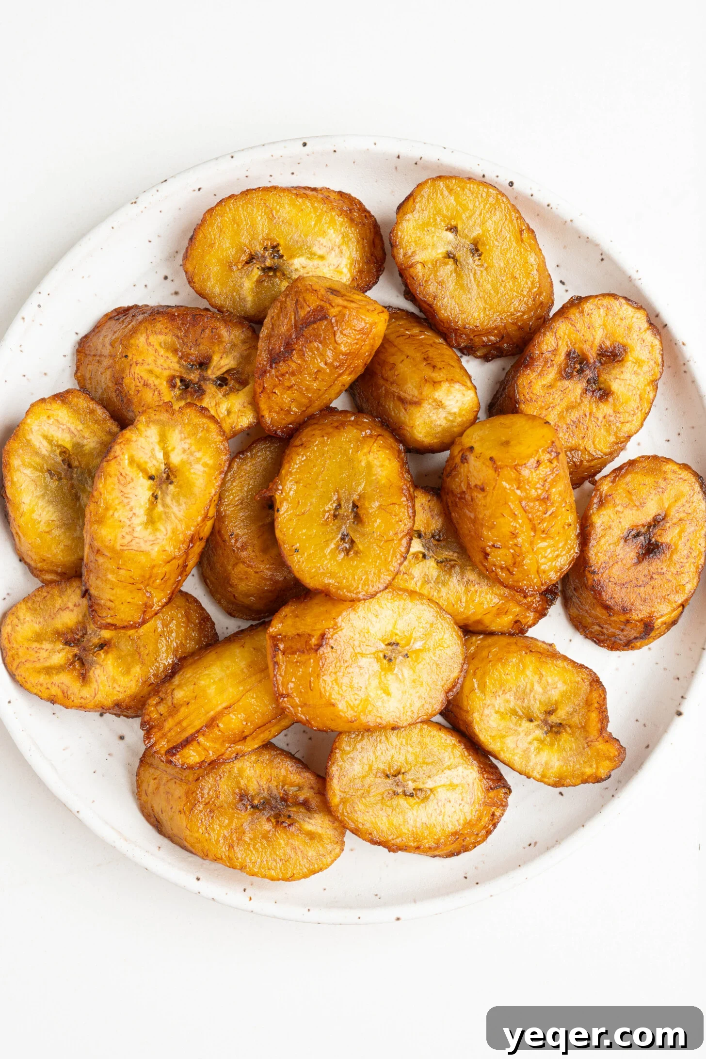 Caramelized Golden Plantains 10 A close-up of a bowl of sweet fried plantains, showing their caramelized texture.