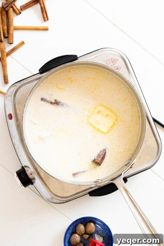 Velvety Rice Dream 4 A saucepan on a stovetop, filled with white rice, water, cinnamon sticks, cloves, and nutmeg, simmering gently, illustrating the first step of making Arroz con Leche.
