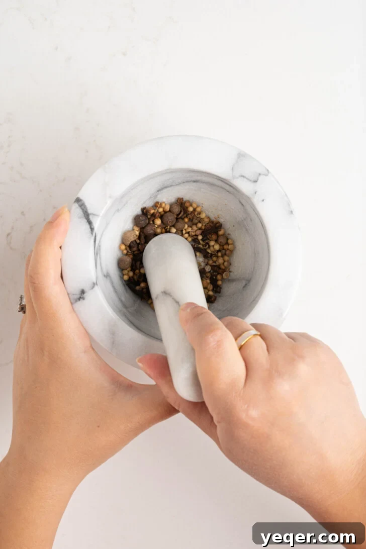 Homemade 5-Minute Ras El Hanout Spice Mix 5 Spices being ground in a mortar & pestle.