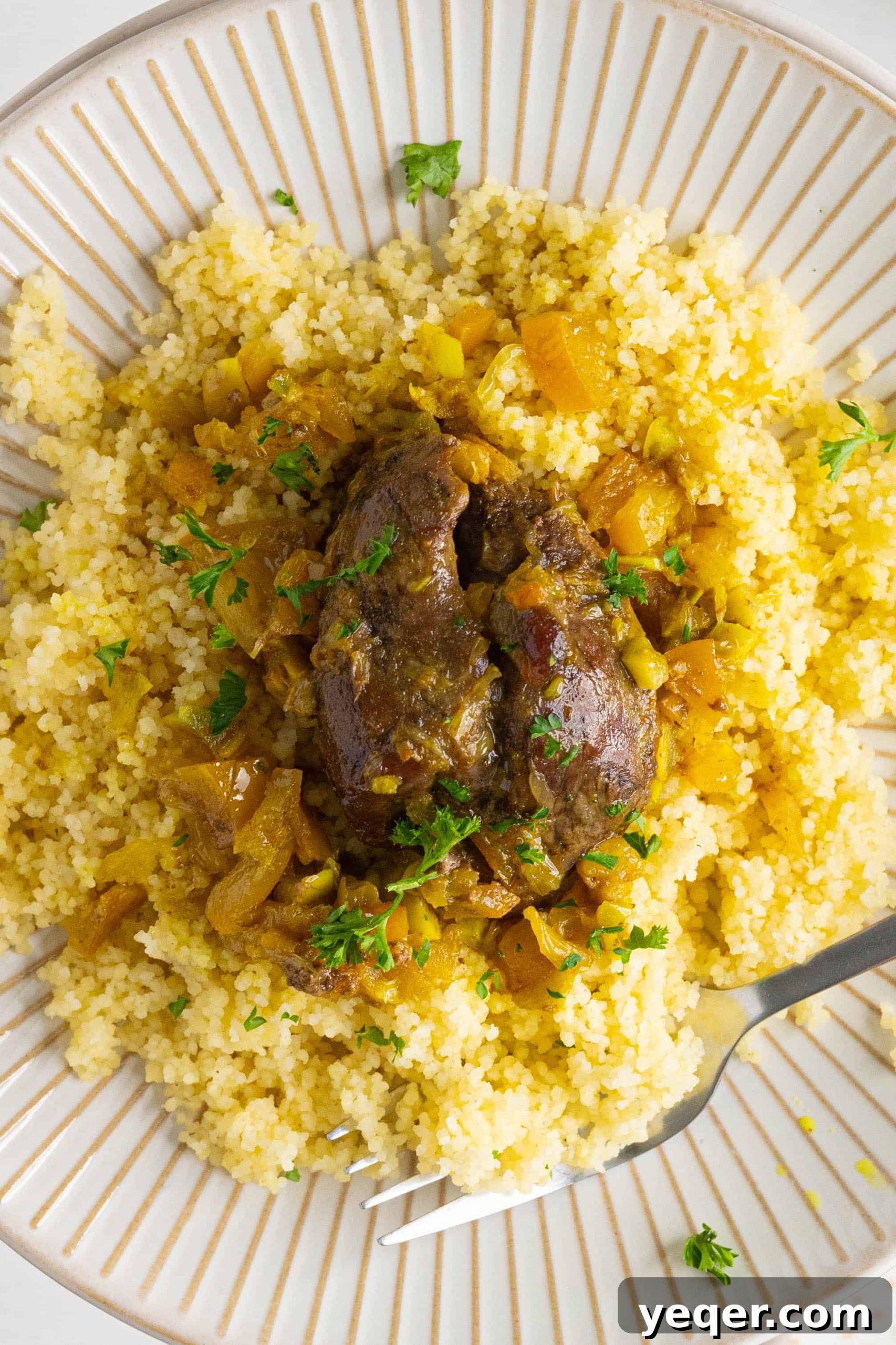 Authentic Moroccan Tangia Lamb Shank Tagine 2 A beautifully presented plate of Moroccan lamb shank tagine, ready to be enjoyed.