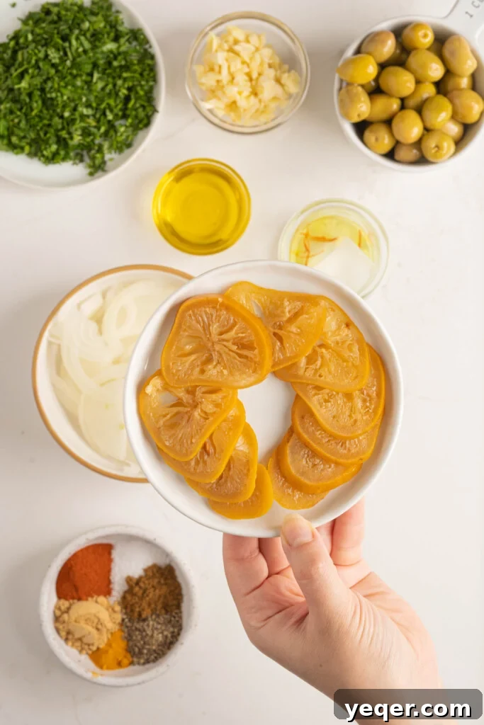 Mastering Moroccan Chicken Tagine at Home 4 a hand holding a plate of preserved lemons