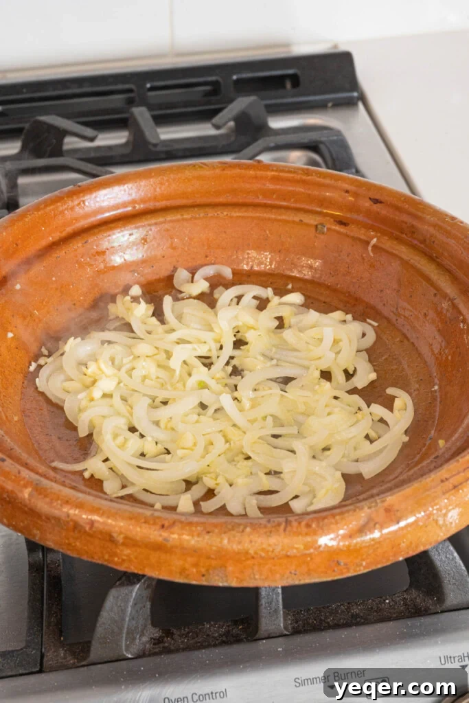 Mastering Moroccan Chicken Tagine at Home 5 onions and garlic in a tagine