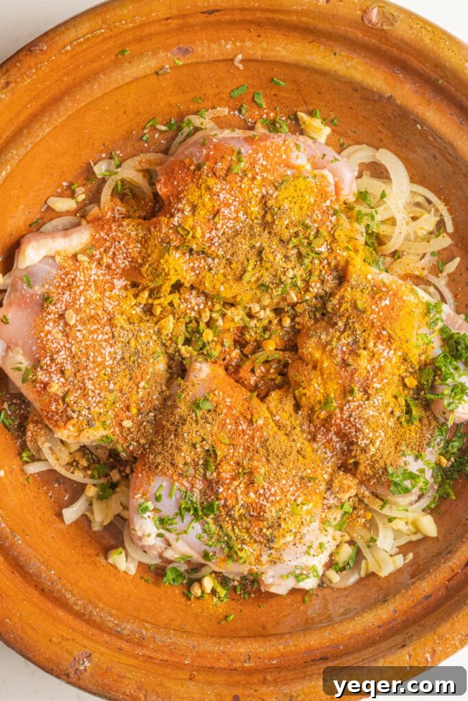 Mastering Moroccan Chicken Tagine at Home 6 raw chicken with spices in a tagine