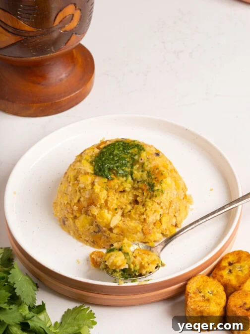 A plate of traditional Puerto Rican Mofongo, garnished for serving, presented within a recipe card layout.
