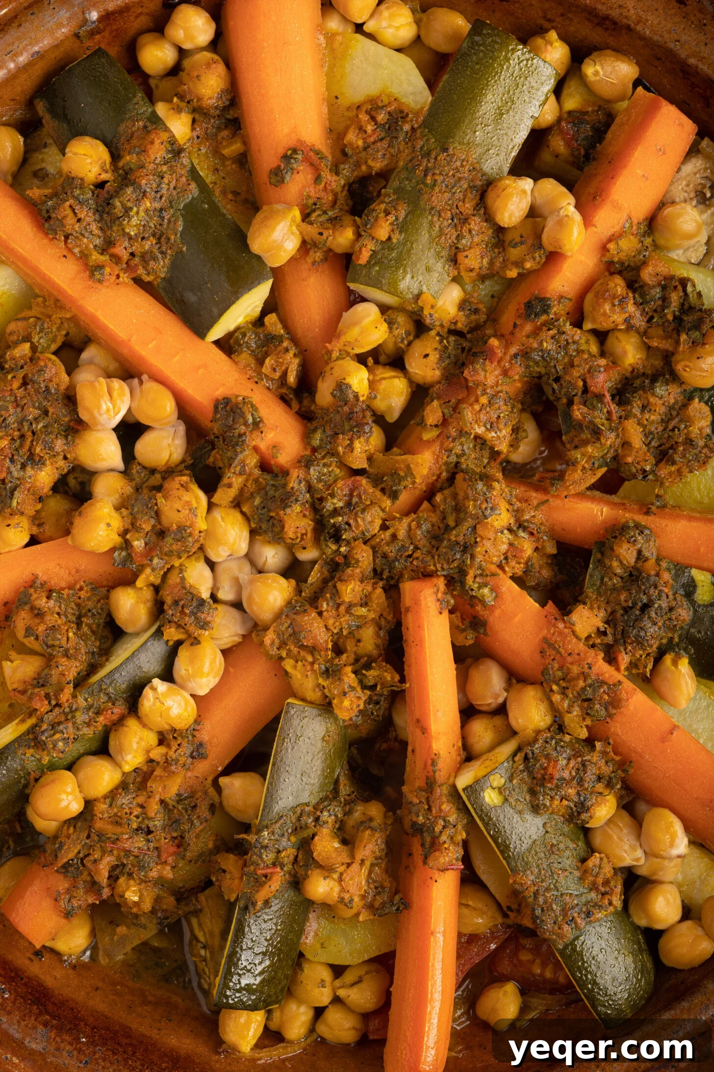 Spiced Moroccan Potato and Vegetable Tagine 13 A visually stunning Moroccan vegetable tagine, steaming hot and ready to be served, showcasing perfectly cooked colorful vegetables and a rich, aromatic sauce in a traditional pot.