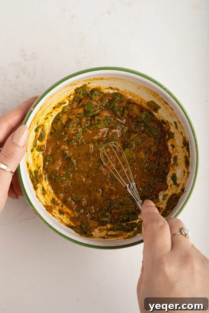 Spiced Moroccan Potato and Vegetable Tagine 8 A small bowl containing a vibrant Moroccan marinade, rich with a blend of spices and fresh herbs, ready to be drizzled over the tagine vegetables for maximum flavor.
