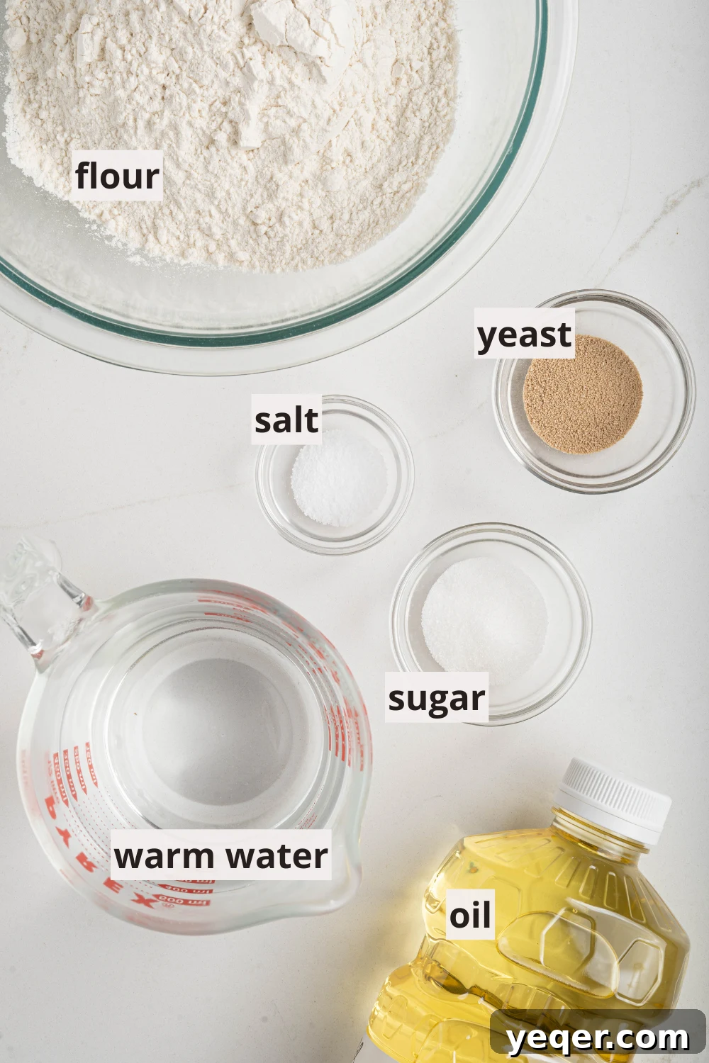 Sfenj: Moroccan Spongy Delights 3 Bowls laid out with essential Sfenj ingredients: flour, yeast, sugar, and salt, ready for mixing.