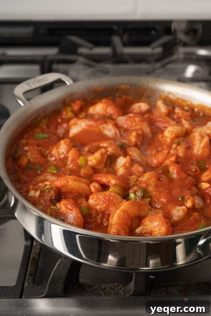 Savory Simmered Shrimp 7 A close-up of fully cooked stewed shrimp in a rich sauce, illustrating its opaque texture.