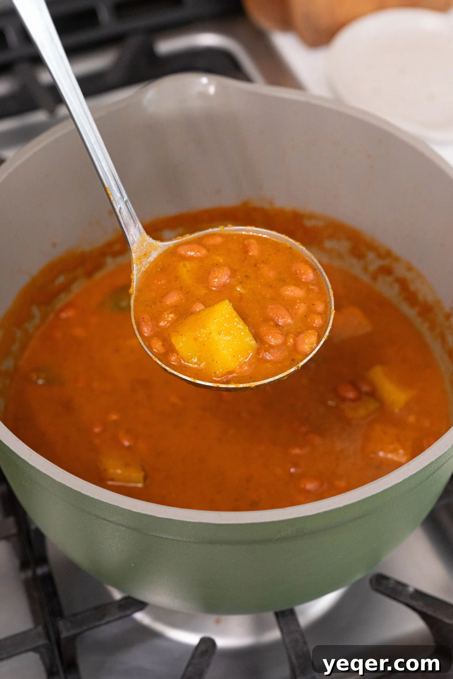 Hearty Puerto Rican Bean Stew 9 A large pot filled with expertly cooked Habichuelas Guisadas, steaming gently and ready to be served to a hungry family, promising warmth and satisfaction.