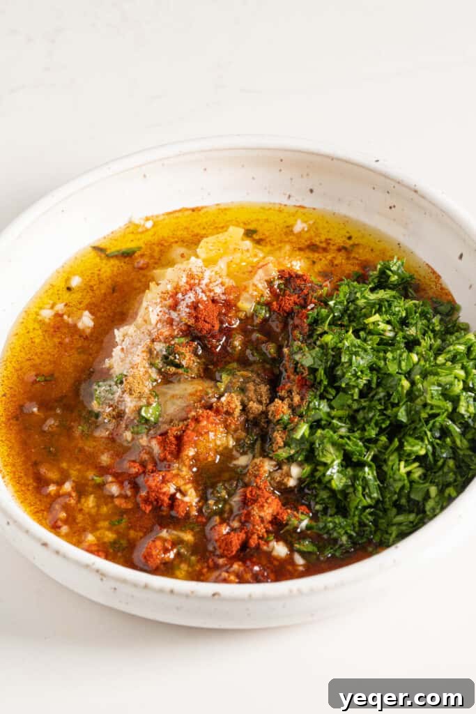 Finely minced ingredients including preserved lemon, fresh herbs, and garlic, ready to be combined for chermoula.