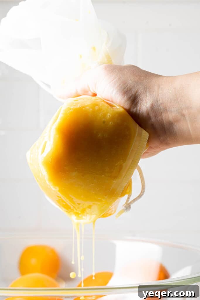 Hand-Pressed Orange Delight 5 Two halves of an orange being squeezed by hand into a glass, demonstrating a simple, no-gadget juicing method.