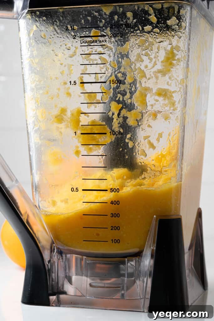 Hand-Pressed Orange Delight 6 A pitcher filled with orange juice pulp and liquid, illustrating the result before straining when using a blender for juicing.
