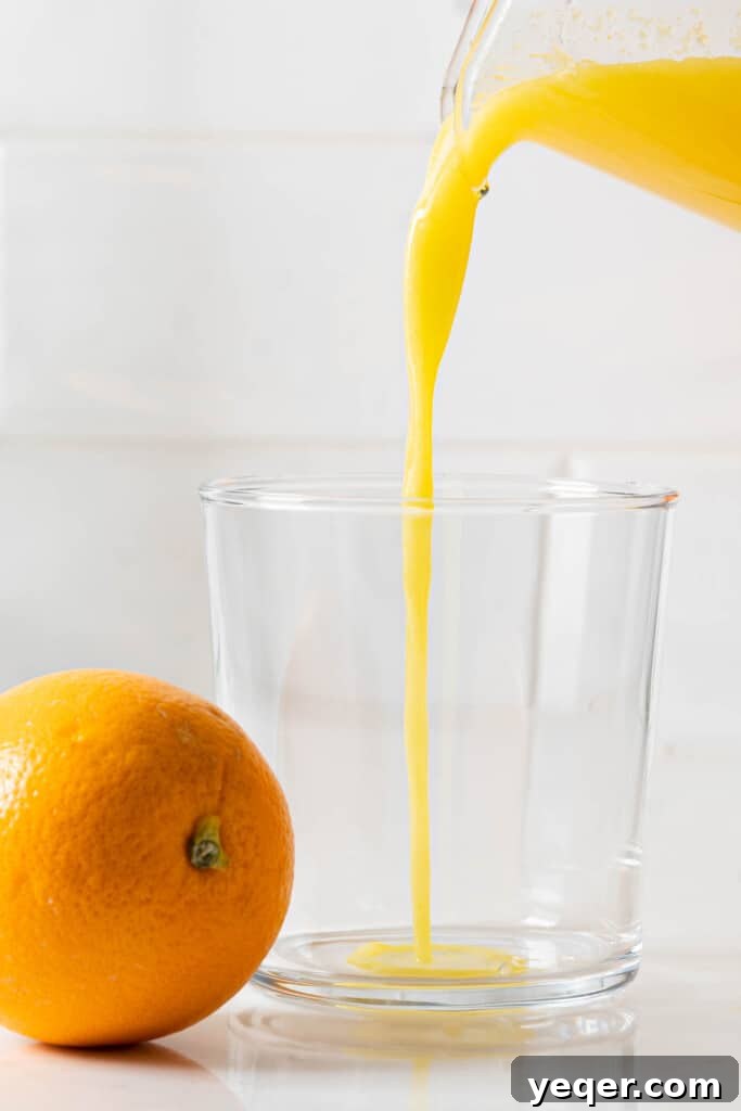 Hand-Pressed Orange Delight 8 A person uses a manual citrus press to extract juice from an orange half, demonstrating a traditional and efficient method.
