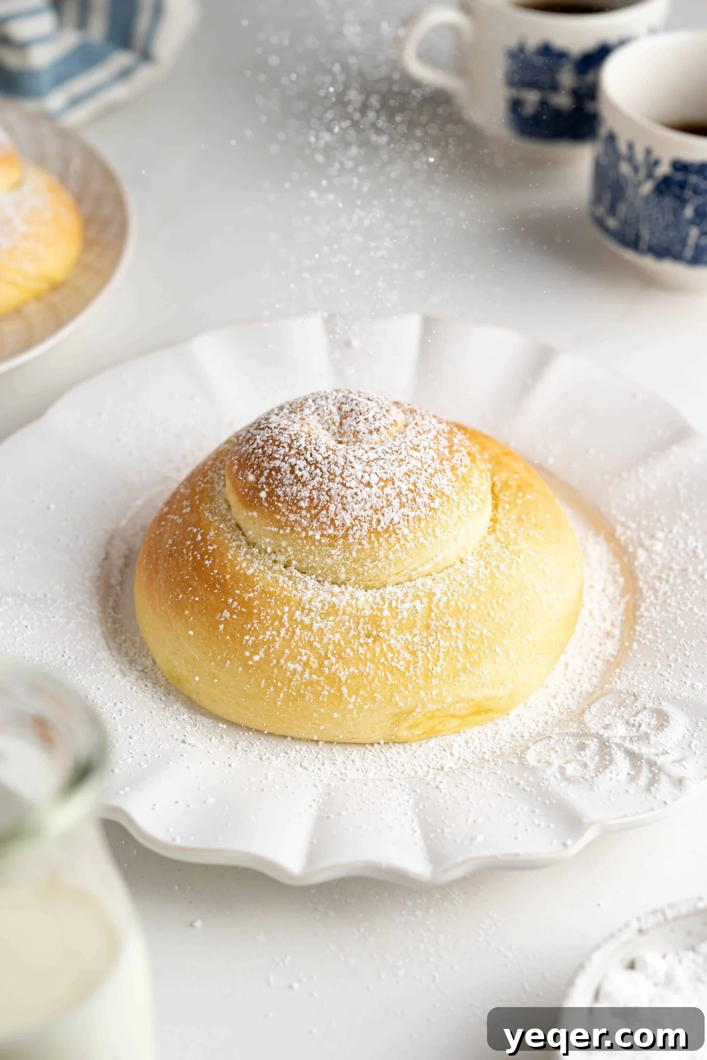 Golden Puerto Rican Sweet Mallorca 2 A beautifully baked Pan de Mallorca sweet bun dusted with powdered sugar, ready to be enjoyed.