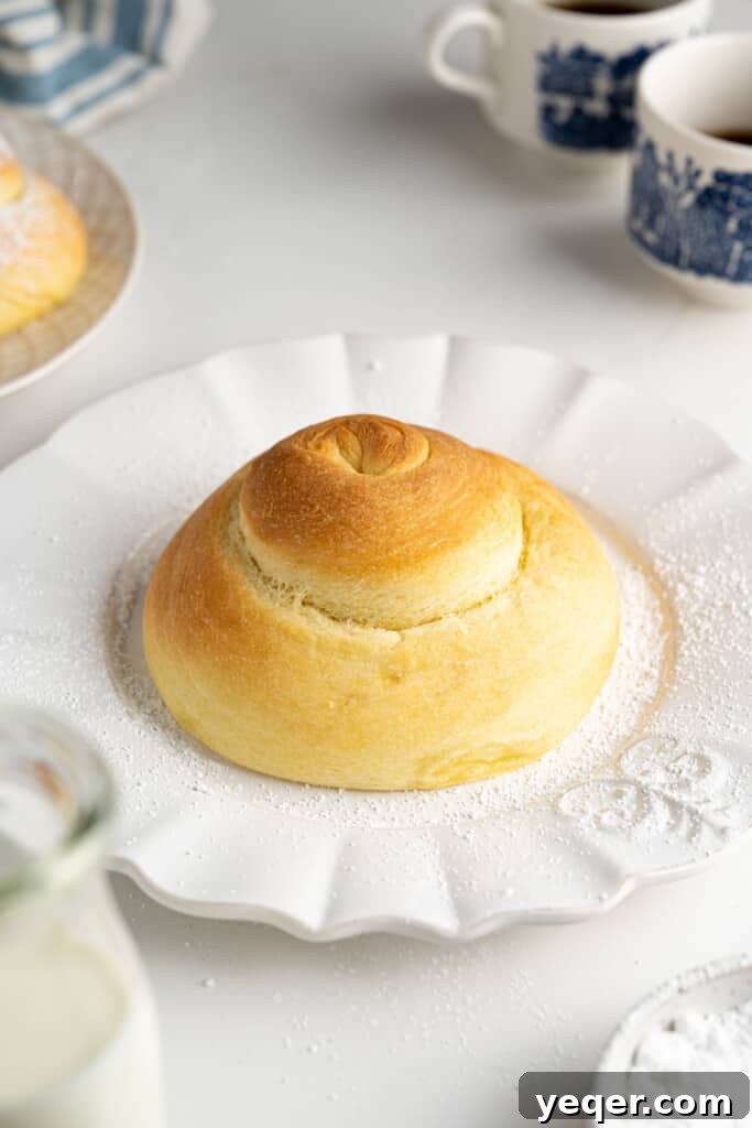 Golden Puerto Rican Sweet Mallorca 12 Freshly baked golden-brown Pan de Mallorca roll on a cooling rack.