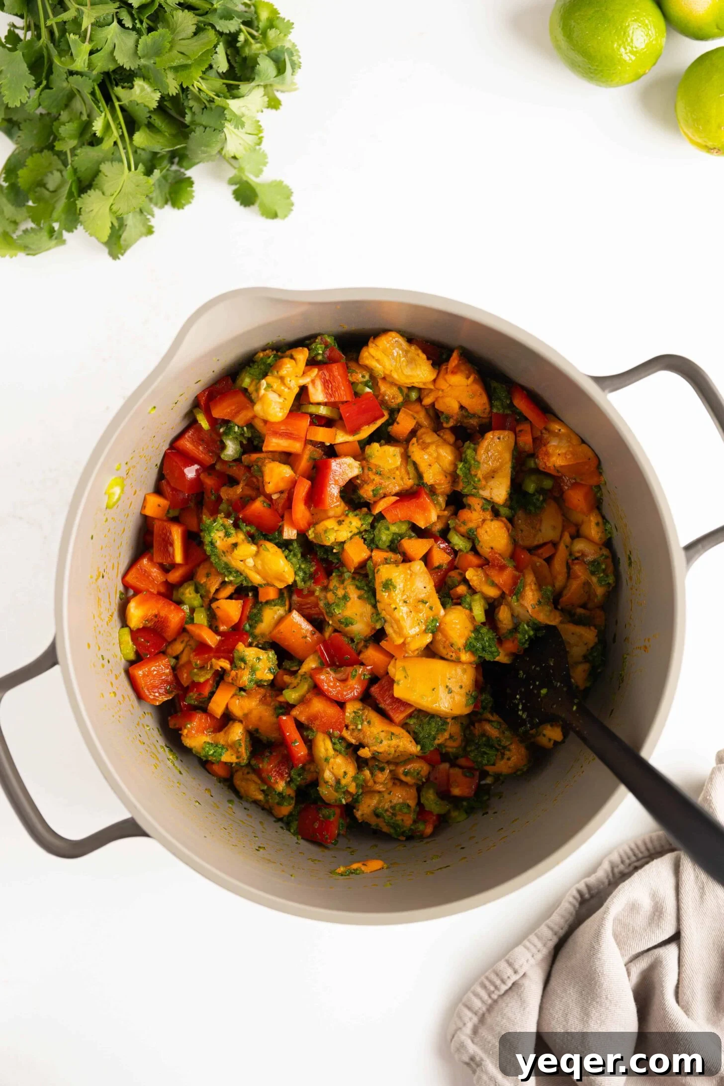 Asopao de Pollo Puerto Rico's Signature Chicken and Rice Stew 5 A pot of chicken with sautéed vegetables, showcasing the rich color.
