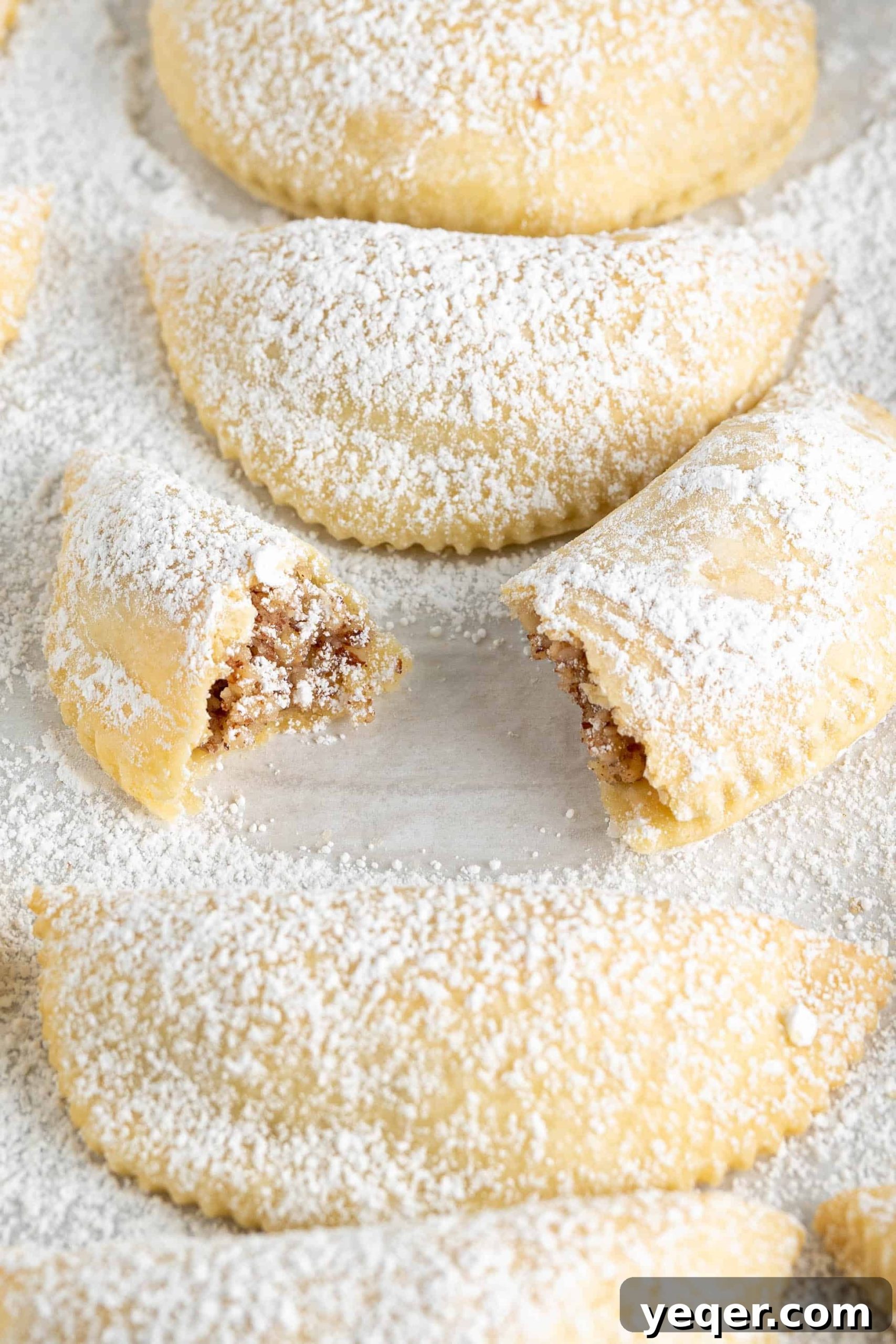 Moroccan Gazelle Horn Almond Crescents 2 gazelle horn cookies on a sugar dusted pan