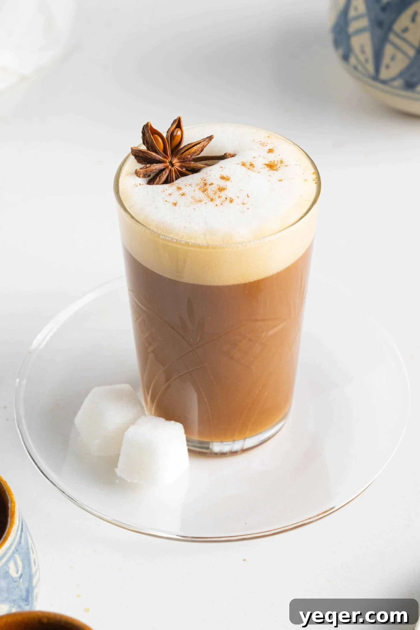 10 Minute Moroccan Coffee Bliss 2 A steaming cup of authentic Moroccan coffee, garnished with a sprinkle of cinnamon and a whole star anise, sitting on a rustic wooden table.